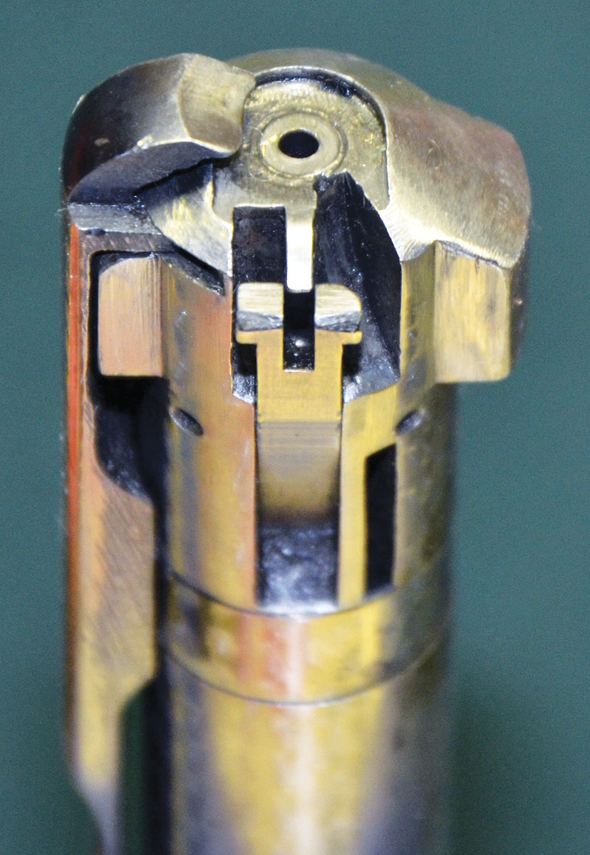 Winchester devoted a lot of time and money to making a cartridge as tiny as the 22 Hornet feed in the large Model 54 action. As the bolt moves forward, a hinged lever (shown here) drops down and pushes the top cartridge in the magazine far enough forward for the face of the bolt to take over and push it into the chamber.